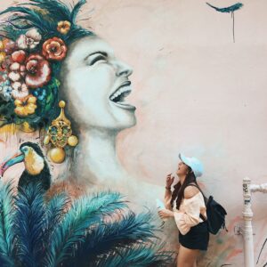 woman laughing with building graffiti