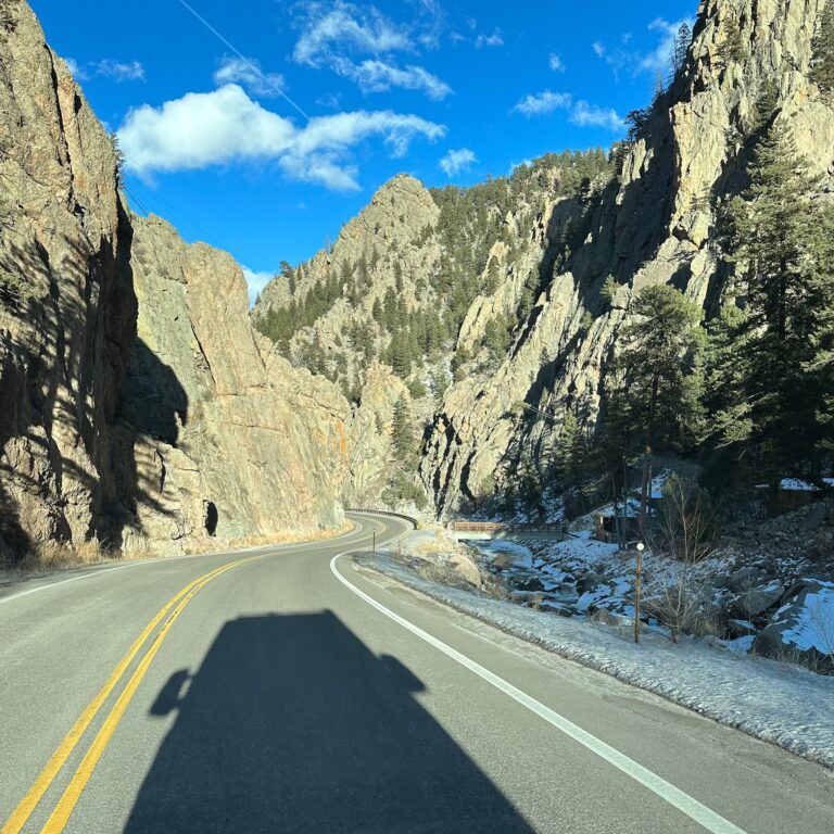 shadow of van driving through mountains