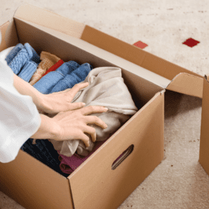 woman organizing clothes in a box
