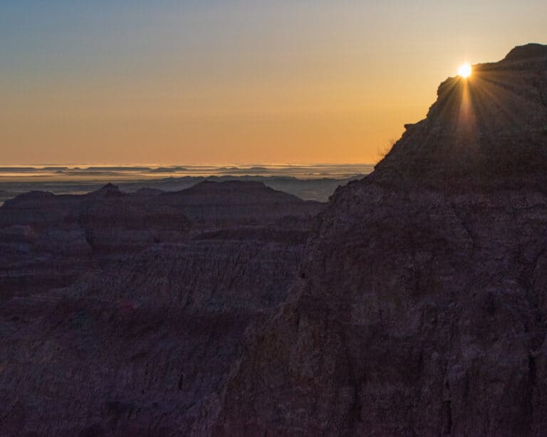 sunrise over a spire in Badlands National Park