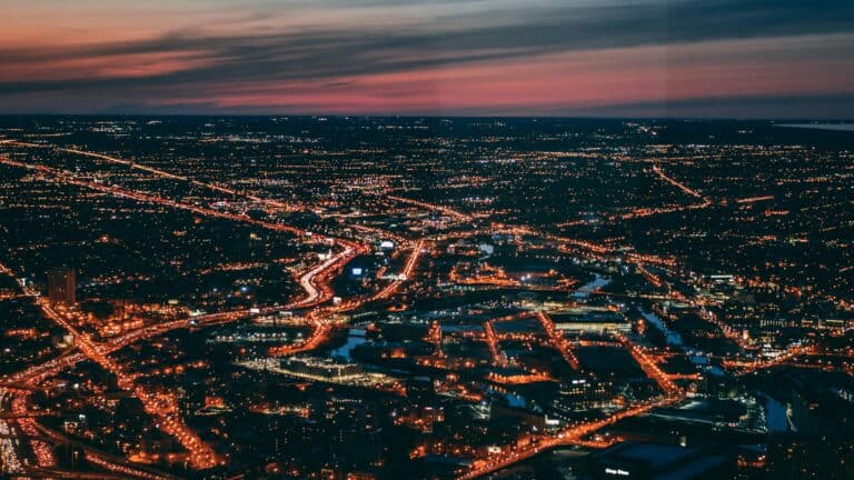 Captivating aerial cityscape of Chicago with illuminated streets and a vibrant dusk sky.